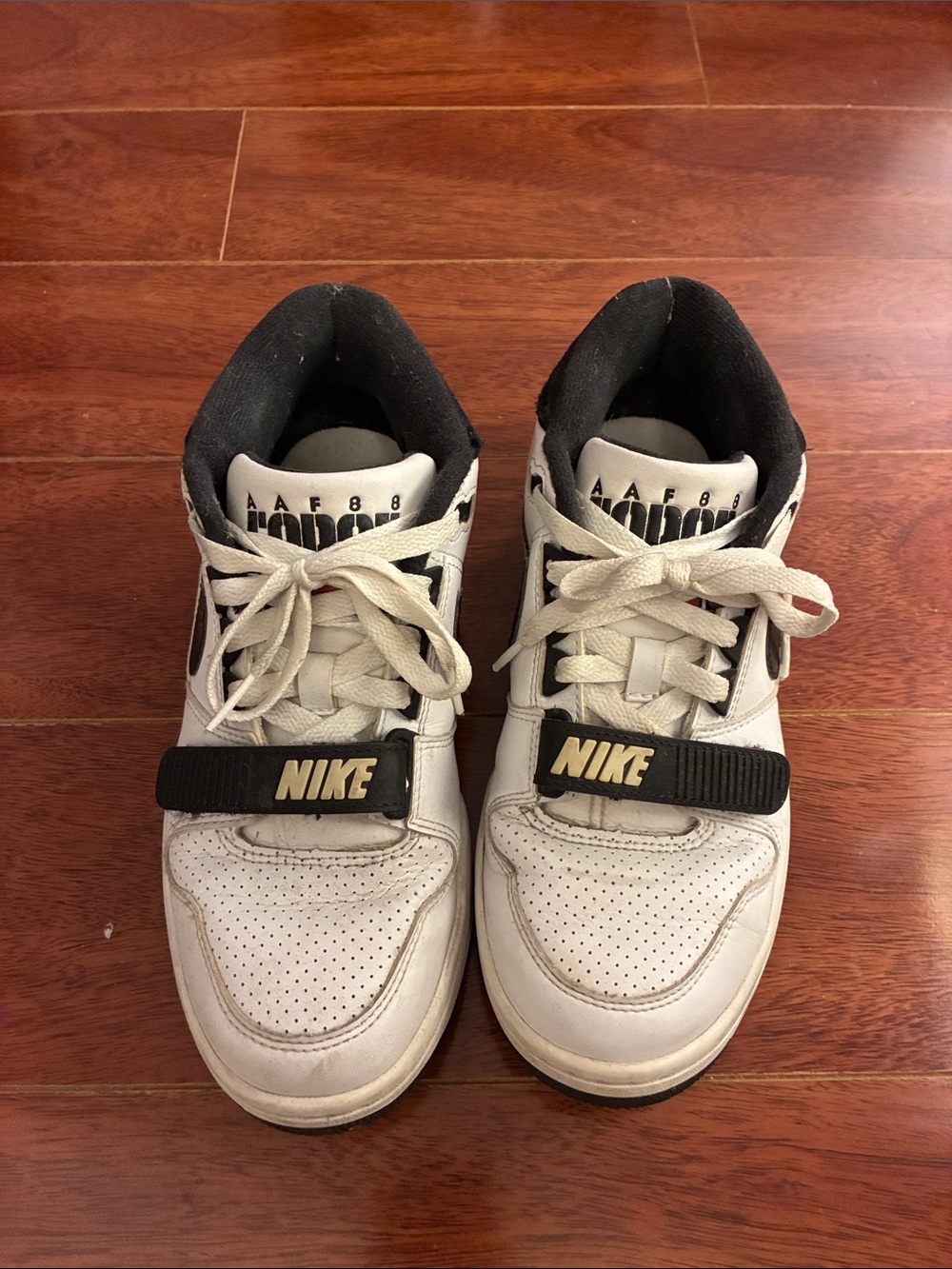 Nike White and Black Low-Top Sneakers with Gold Logo Strap